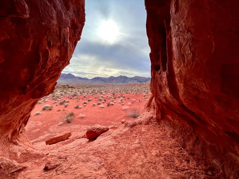 Desert plain framed by a red sandstone alcove, one of the quieter things to do in Valley of Fire State Park, Nevada